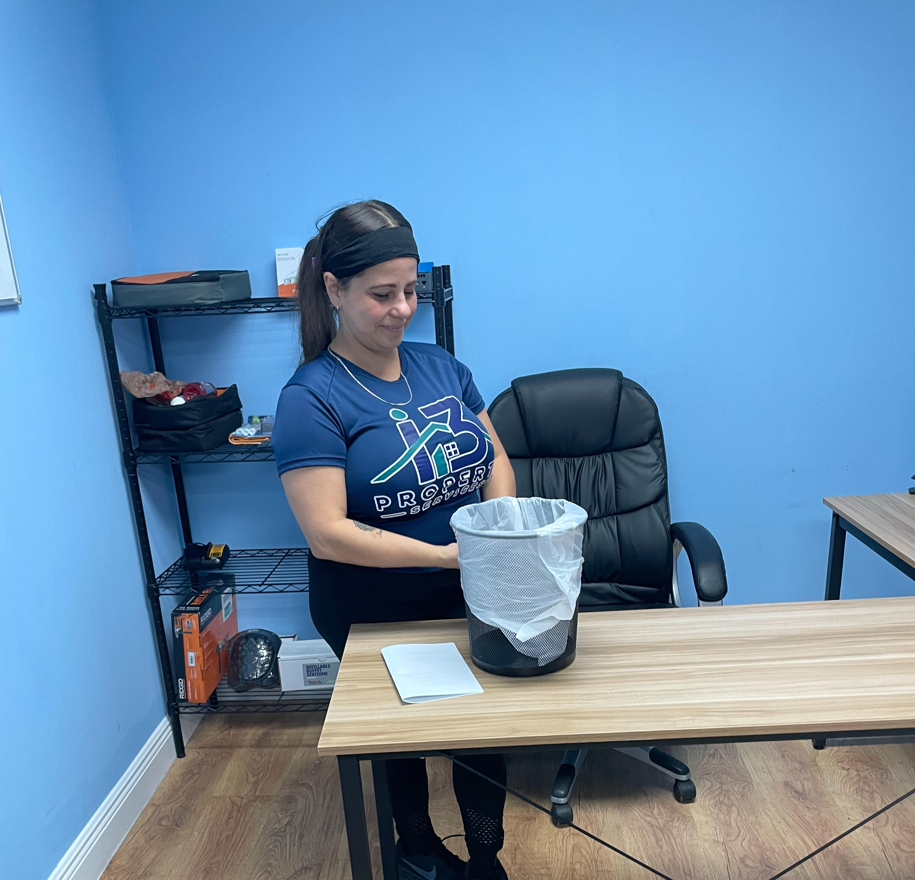 i3 Property Services team member cleaning a workplace table